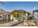 Charming bungalow with yellow accents, covered porch, and inviting curb appeal at 2421 Hooker St, Denver, CO 80211