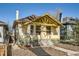 Inviting bungalow with a covered front porch, mature landscaping, and craftsman details at 2421 Hooker St, Denver, CO 80211