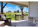 Relaxing covered patio with comfortable seating and views of the green landscape beyond the fenced yard at 8052 Mount Kataka St, Littleton, CO 80125