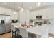 Bright kitchen featuring white cabinets, stainless steel appliances and a large island with seating for casual dining at 8052 Mount Kataka St, Littleton, CO 80125