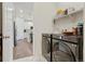 Modern laundry room with gray washer and dryer, white cabinetry, and access to the kitchen at 8052 Mount Kataka St, Littleton, CO 80125