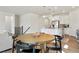 Open concept living room and kitchen area with hardwood floors, stainless steel appliances, and a center island at 8052 Mount Kataka St, Littleton, CO 80125