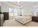 Spacious main bedroom with tray ceiling, large windows, and neutral-colored walls and carpet at 8052 Mount Kataka St, Littleton, CO 80125