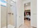 Modern shower with sleek fixtures and tile surround, leading to a well-organized walk-in closet at 8052 Mount Kataka St, Littleton, CO 80125