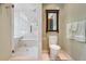 Modern bathroom featuring glass shower, white tile, and minimalist design at 5530 E 6Th Avenue Pkwy, Denver, CO 80220