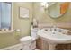 Charming powder room with a pedestal sink and elegant fixtures at 5530 E 6Th Avenue Pkwy, Denver, CO 80220