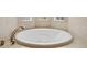 Large soaking tub with bronze fixtures and a tile surround at 5530 E 6Th Avenue Pkwy, Denver, CO 80220