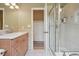 Tiled bathroom featuring glass-enclosed shower, stylish vanity, and well-lit space at 5530 E 6Th Avenue Pkwy, Denver, CO 80220