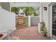 Charming courtyard featuring a decorative fountain, brick patio, and white pergola with climbing plants at 5530 E 6Th Avenue Pkwy, Denver, CO 80220
