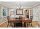 Well-lit dining room with a large wooden table, decorative mirror, and modern light fixture at 5530 E 6Th Avenue Pkwy, Denver, CO 80220
