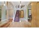 Elegant foyer featuring a grand staircase with decorative carpet and hardwood floors at 5530 E 6Th Avenue Pkwy, Denver, CO 80220