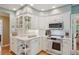 Well-organized kitchen featuring white cabinets, modern appliances, and tile countertops at 5530 E 6Th Avenue Pkwy, Denver, CO 80220