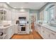 Bright kitchen with white cabinetry, modern appliances, and hardwood floors at 5530 E 6Th Avenue Pkwy, Denver, CO 80220
