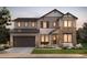 Charming two-story home showcasing stone accents, a two car garage, and manicured front lawn at 8465 Silverton Ln, Littleton, CO 80125