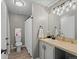 Well-lit bathroom with a toilet, vanity, tile countertop, and plenty of open space at 5726 N Genoa Way # 201, Aurora, CO 80019