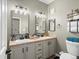 Modern bathroom featuring a double vanity with elegant black fixtures and ample storage space at 5726 N Genoa Way # 201, Aurora, CO 80019