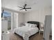 Bright bedroom with a ceiling fan and private balcony access at 5726 N Genoa Way # 201, Aurora, CO 80019