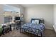 Bright bedroom with a blue-patterned bed, desk area, and large window offering great views at 5726 N Genoa Way # 201, Aurora, CO 80019