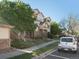 The exterior view showcases well-manicured lawns, mature trees, and convenient parking in this beautiful neighborhood at 5726 N Genoa Way # 201, Aurora, CO 80019
