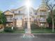 Inviting condo exterior boasts a well-maintained lawn, mature trees, and private balconies for relaxing outdoor living at 5726 N Genoa Way # 201, Aurora, CO 80019