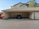 Covered parking garage with a parked car in the space at 5726 N Genoa Way # 201, Aurora, CO 80019