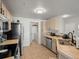 Bright kitchen with tile floors, stainless steel appliances, and ample counter space at 5726 N Genoa Way # 201, Aurora, CO 80019