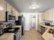 Well-lit kitchen featuring tile floors, neutral cabinets and modern appliances at 5726 N Genoa Way # 201, Aurora, CO 80019