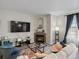 Comfortable living room features a corner fireplace, neutral walls, and a large television for cozy nights in at 5726 N Genoa Way # 201, Aurora, CO 80019