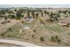 Wide aerial view of a home on a sprawling lot with a barn, shed, and lush surrounding landscape at 1233 Starling Ln, Elizabeth, CO 80107