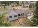 Aerial view of a single-Gathering home with a large yard surrounded by mature trees and lush landscape at 1233 Starling Ln, Elizabeth, CO 80107
