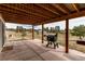 Covered backyard patio with a grill, providing an ideal setting for outdoor entertaining and relaxation at 1233 Starling Ln, Elizabeth, CO 80107
