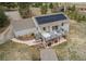 Birds-eye view of a home featuring a spacious deck with outdoor seating, solar panels, and a shed at 1233 Starling Ln, Elizabeth, CO 80107