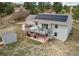 An aerial view of a home's backyard, featuring a spacious deck with outdoor seating and solar panels at 1233 Starling Ln, Elizabeth, CO 80107