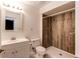 This bathroom features a wood paneled shower and a white vanity at 1233 Starling Ln, Elizabeth, CO 80107