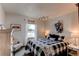 Cozy bedroom features a plaid bed set and a large window with natural light at 1233 Starling Ln, Elizabeth, CO 80107