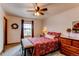 Comfortable bedroom with a ceiling fan, natural light, and a neutral color scheme, with wood furniture at 1233 Starling Ln, Elizabeth, CO 80107