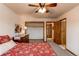 Bright bedroom with a ceiling fan, carpet, natural light, closet space, and neutral walls at 1233 Starling Ln, Elizabeth, CO 80107