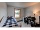 Bright bedroom features a plaid bed set, desk, and a window with natural light at 1233 Starling Ln, Elizabeth, CO 80107