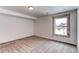 This bedroom features light carpet and a window at 1233 Starling Ln, Elizabeth, CO 80107