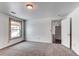 This bedroom features light carpet, a window, and an open doorway at 1233 Starling Ln, Elizabeth, CO 80107