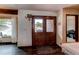 Inviting entryway featuring a beautiful stained wood door, hardwood floors, and natural light at 1233 Starling Ln, Elizabeth, CO 80107