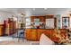Well-lit kitchen featuring an island with granite countertops, wooden cabinets, and modern appliances at 1233 Starling Ln, Elizabeth, CO 80107