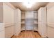 Spacious walk-in closet with custom white shelving and cabinets, offering ample storage and organization at 1233 Starling Ln, Elizabeth, CO 80107