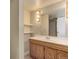 Bathroom featuring wood vanity with marble top, shelving unit, and updated fixtures at 4755 S Irving St, Englewood, CO 80110