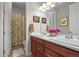 Bright bathroom with double sinks, wooden cabinets, and framed artwork adding a touch of elegance at 6705 S Catawba Way, Aurora, CO 80016