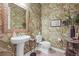 Charming powder room featuring botanical wallpaper, pedestal sink, and elegant decorative accents at 6705 S Catawba Way, Aurora, CO 80016