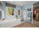Luxurious bathroom with a soaking tub, glass-enclosed shower, and a walk-in closet at 6705 S Catawba Way, Aurora, CO 80016