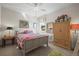 Cozy bedroom with a patterned quilt, natural light, and a vintage-style armoire at 6705 S Catawba Way, Aurora, CO 80016