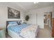 Bright bedroom featuring white walls, ceiling fan, carpet, and closet with ensuite bathroom at 6705 S Catawba Way, Aurora, CO 80016