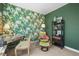 Cozy bedroom featuring floral wallpaper and a sitting area with stylish chair and ottoman at 6705 S Catawba Way, Aurora, CO 80016